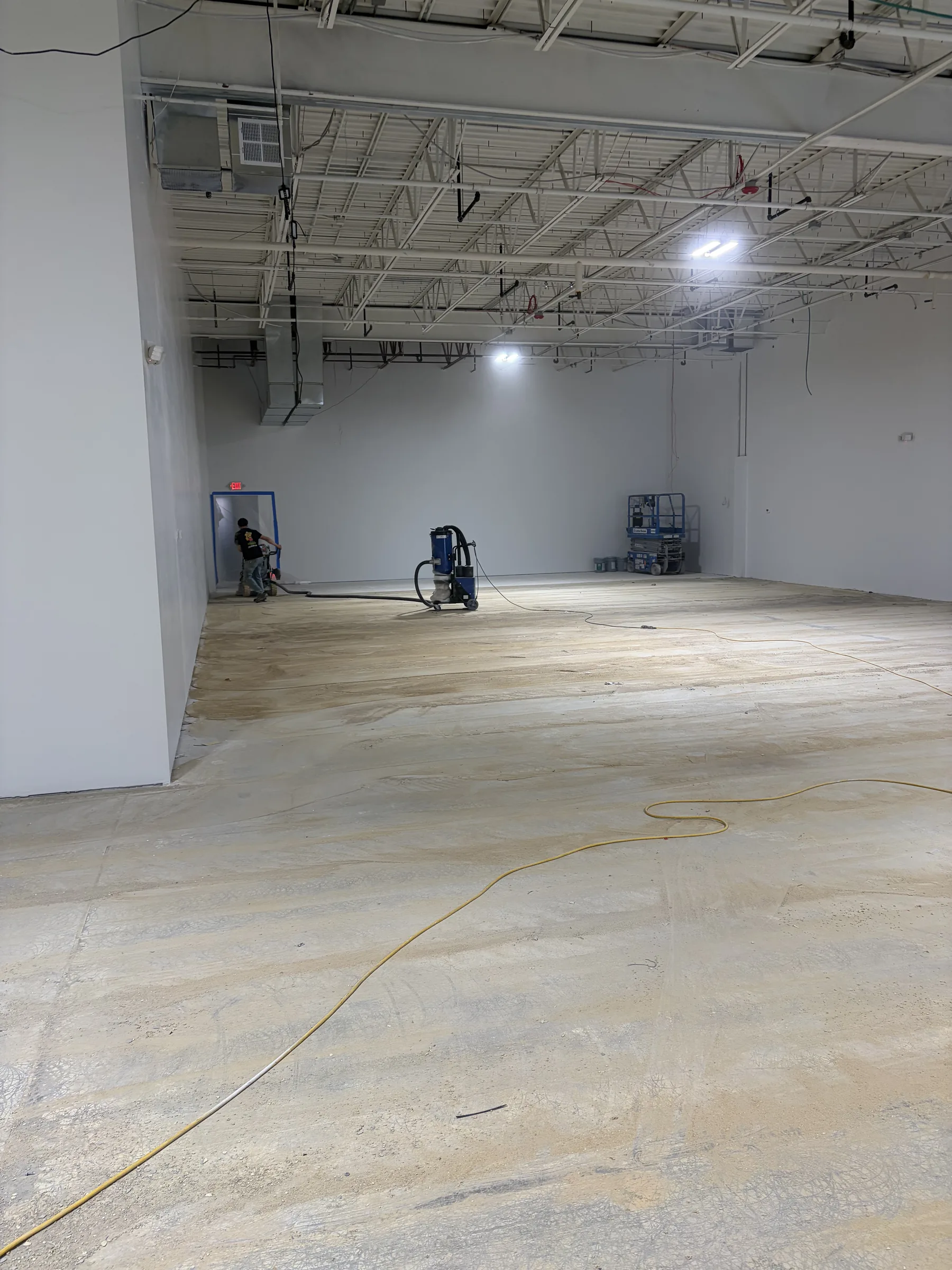 Triumph Concrete Coating Commercial diamond grinder preparing a raw concrete slab